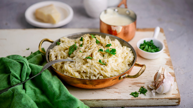 Pot of fettuccine Alfredo with fresh herbs