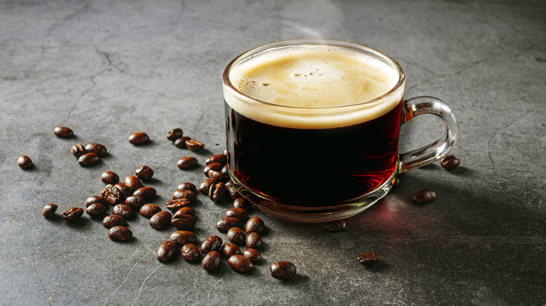 Cup of coffee with coffee beans