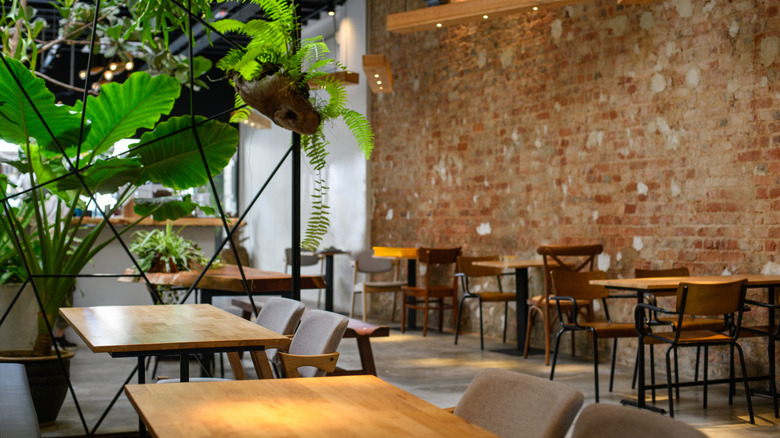 Empty restaurant with wooden tables and chairs