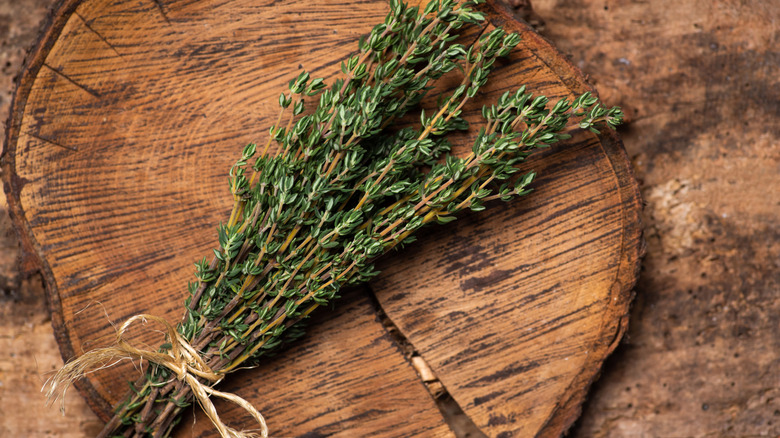 Bundle of herbs on wooden cutting board