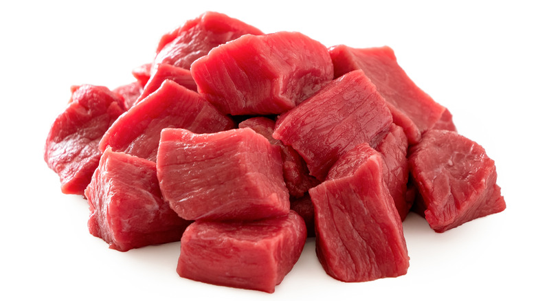 Pile of beef chunks on white background