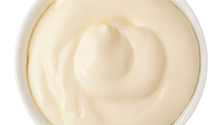 Mayonnaise in white bowl on white background