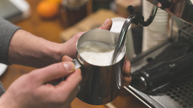 A barista steaming milk