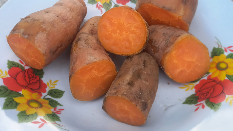 Boiled sweet potatoes on white and floral plate