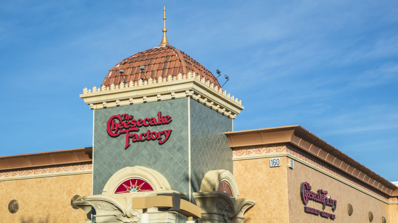 The Cheesecake Factory sign on building against blue sky