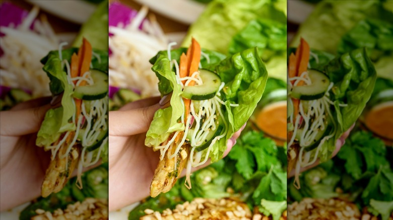 Hand holding lettuce wrap at The Cheesecake Factory