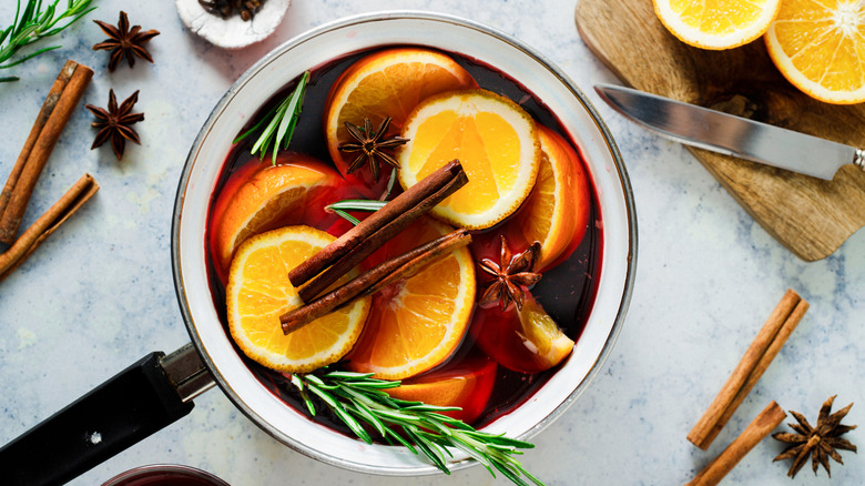 Mulled wine with garnishes in white pot