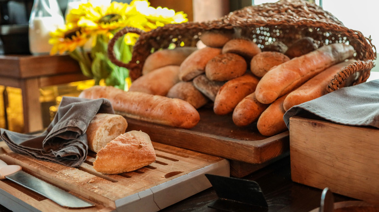 A variety of food products containing carbs, like pasta, bread, crackers, and donuts.