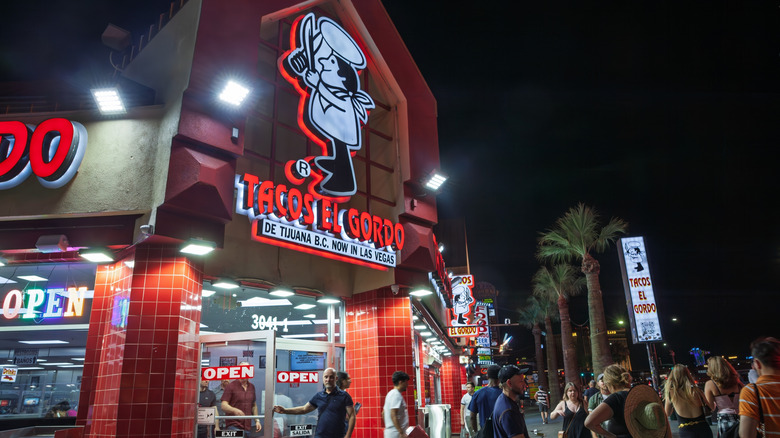 A small crowd outside Tacos El Gordo in Las Vegas at night