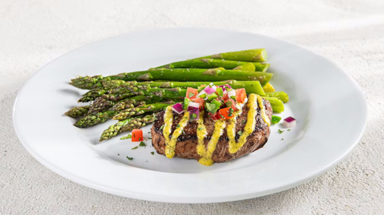 Sirloin steak on a white plate with asparagus at Chili's