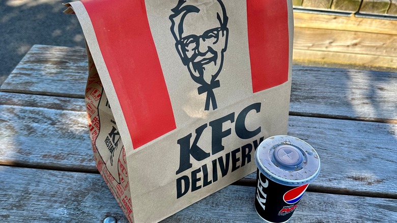 KFC delivery bag with drink on table