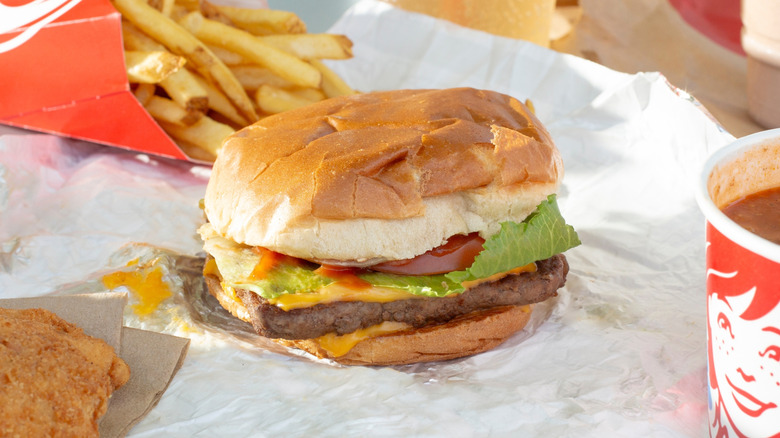 Wendy's burger surrounded by side dishes