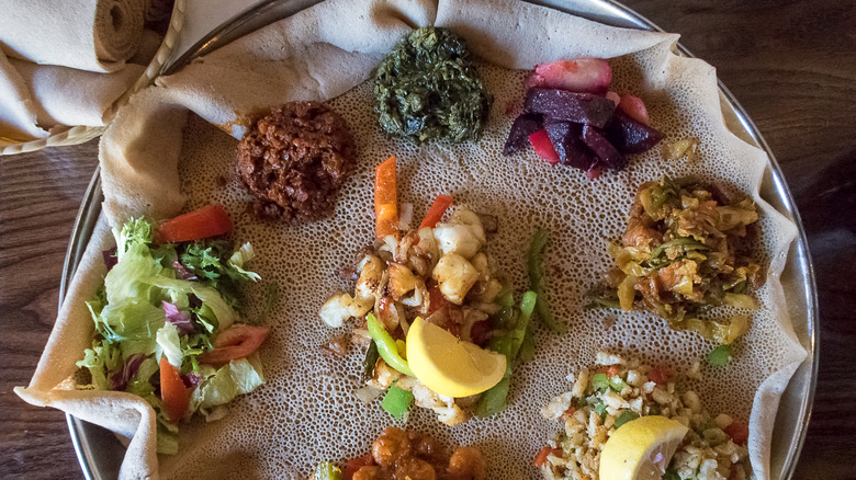 Ethiopian dishes on plate of injera