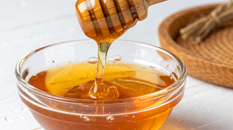 Honey in glass bowl on table