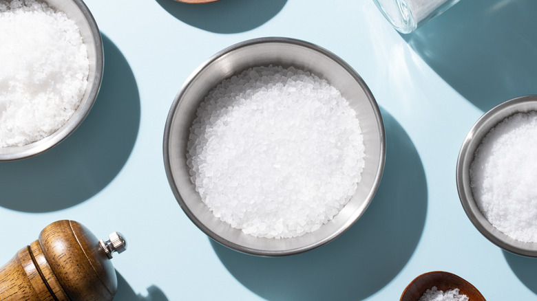 Salt in metal bowl on blue table