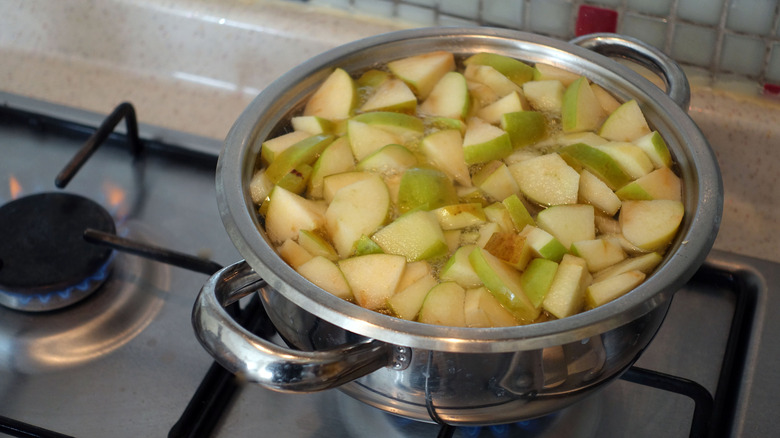 Boiling chopped apple pieces in pot