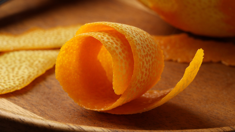 Twisted orange peel on wooden table