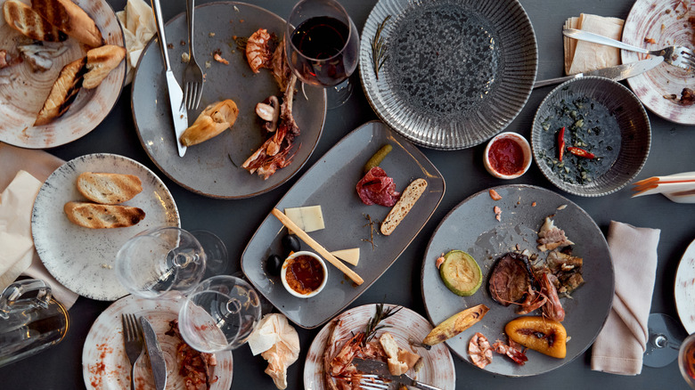 A table covered in leftover food dishes