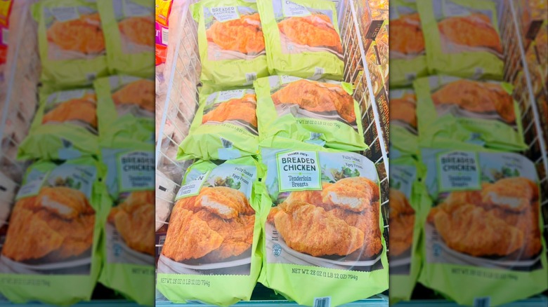 Green bags of Breaded Chicken Tenderloin Breasts in store freezer