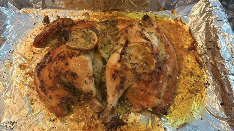 Spatchcocked Lemon Rosemary Chicken on foil-lined tray