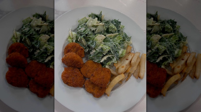 Trader Joe's Spicy Chicken Nuggets on plate with fries and salad