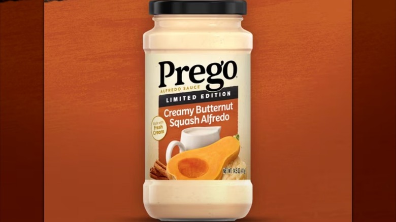 A jar of Prego limited edition Butternut Squash Alfredo on an orange backdrop
