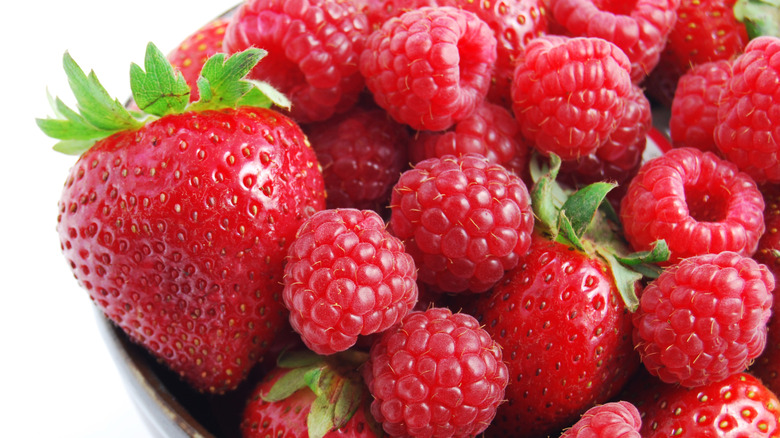 Close up of strawberries and raspberries in bowl
