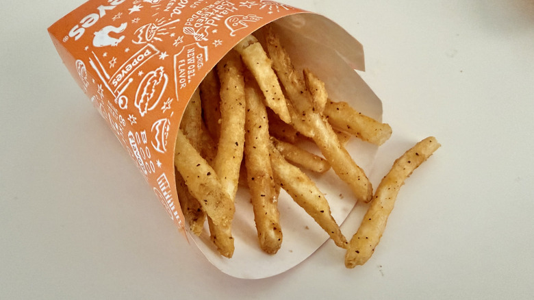 Cajun Fries on a container on a table
