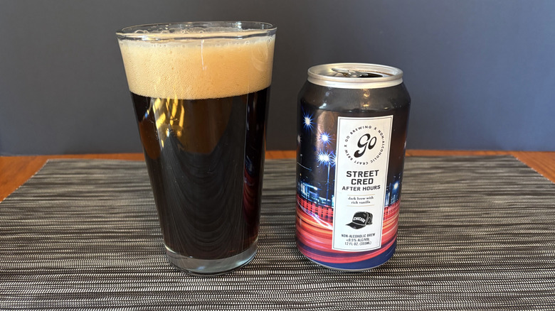 Go Brewing street cred after hours non-alcoholic brew in glass and can on dark background