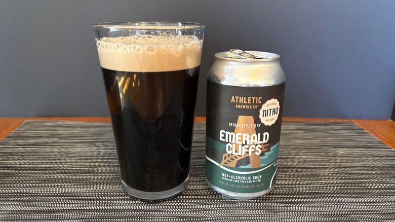 Athletic emerald cliffs non-alcoholic brew in glass and can on dark background