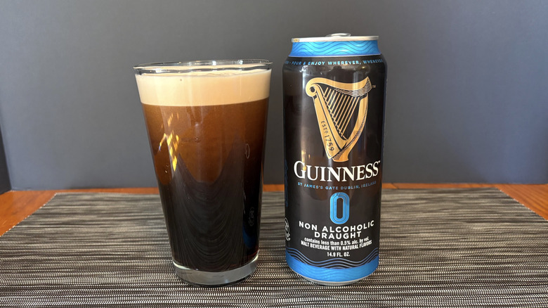 Guinness 0 in can and glass on a dark background