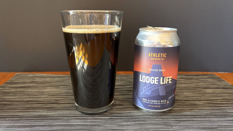 Athletic lodge life non-alcoholic brew in can and glass on dark background