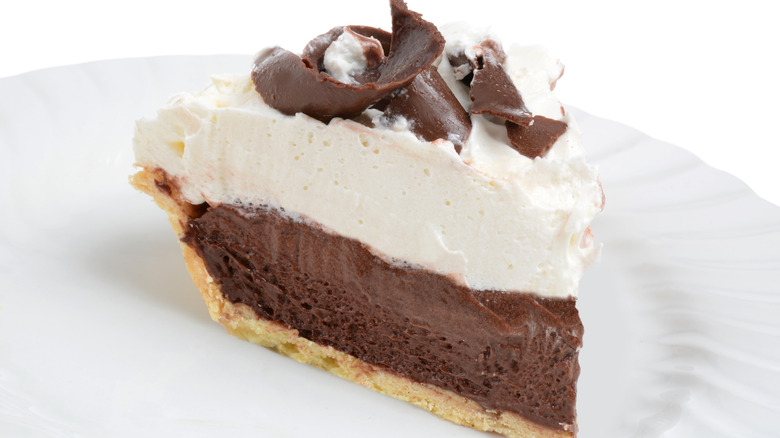Chocolate pie topped with whipped topping and chocolate curls