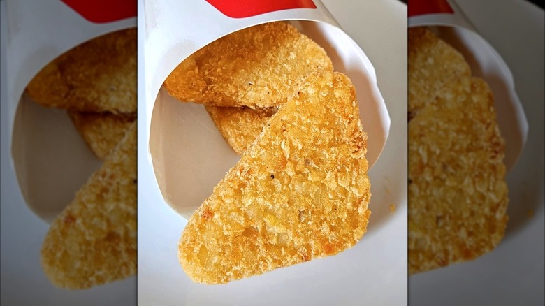 Arby's Potato Cakes hash browns inside white cardboard sleeve