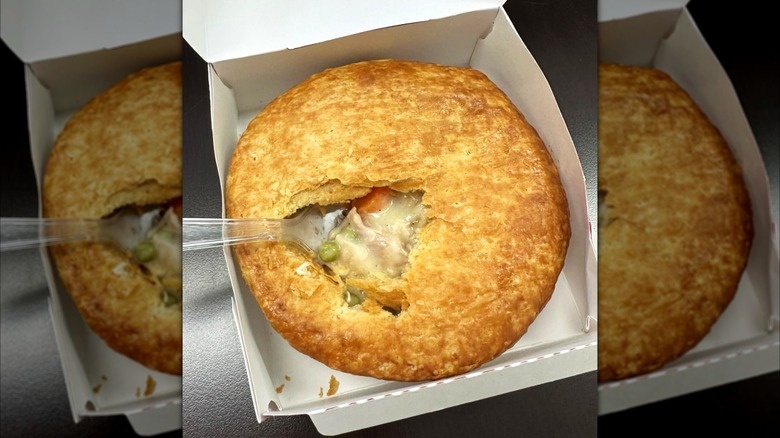 KFC Chicken Pot Pie with filling showing through hole in crust inside white box with plastic fork