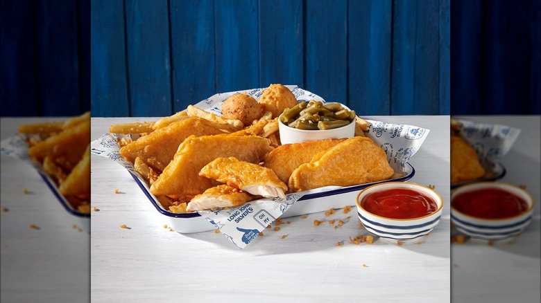 Long John Silver's fried chicken and fish platter with hush puppies, green beans, and side cup of ketchup