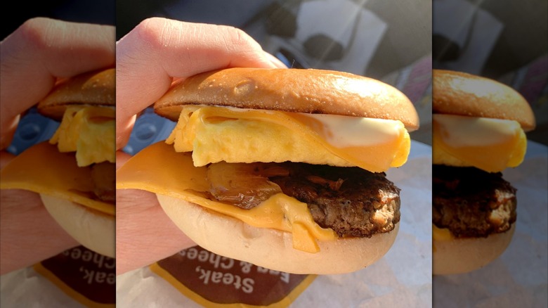 Hand holding McDonald's Steak, Egg & Cheese Bagel