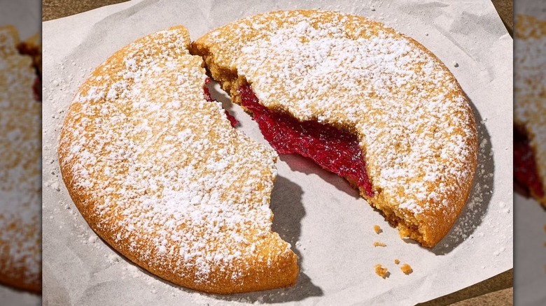 Panera Bread PB&J Cookie split in half on white wax paper