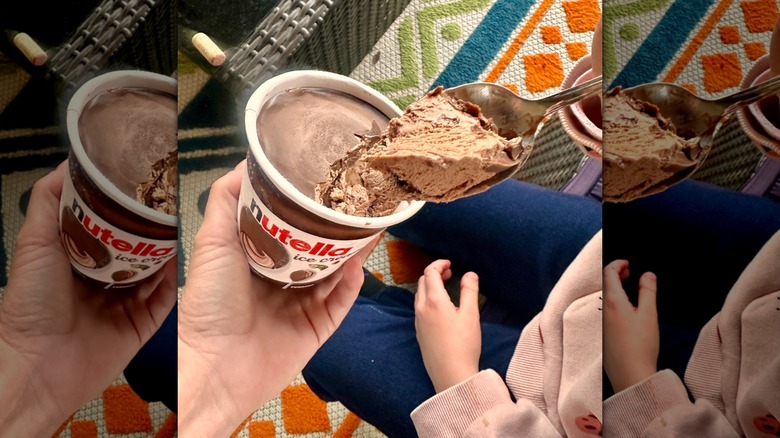 hand holds pint of Nutella ice cream with spoon scoop