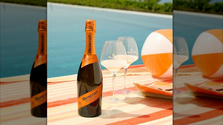 Bottle of Mionetto by the pool