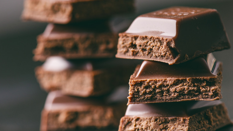 Two piles of chocolate on a dark background