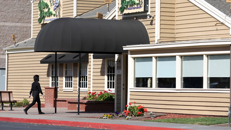 A worker enters an Olive Garden restaurant