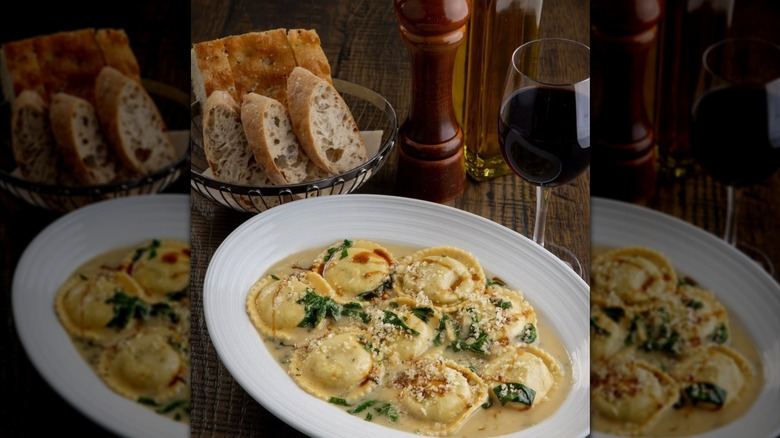 plate of ravioli, bread, and wine at a restaurant