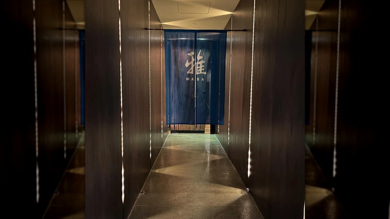 brown corridor with door to Masa restaurant at the end, mirrored image