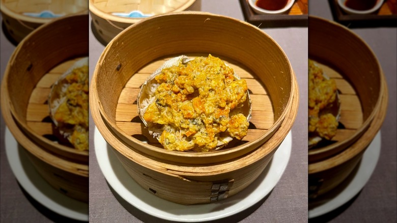 Crab dish in wooden container on white plate at Sazenka, mirrored image