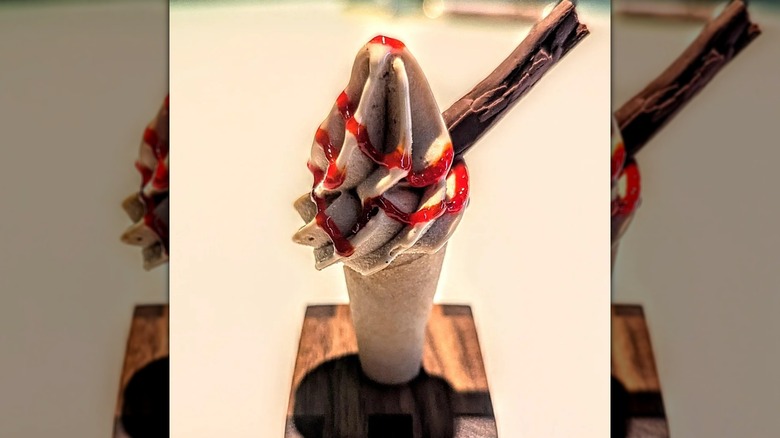 a crab and passionfruit 99 style ice cream on wooden block, mirrored image