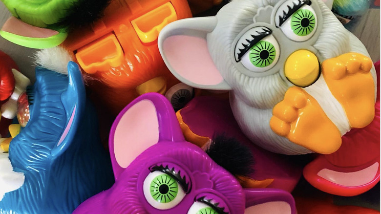 Close up of McDonalds McFurbys from 1998 in grey, pink, blue and orange