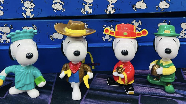 Close up of four Snoopy World Tour figurines from different countries