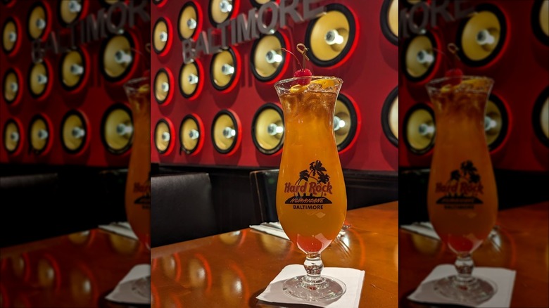 Hard Rock Cafe Hurricane cocktail on a table with red wall behind it, with mirror borders
