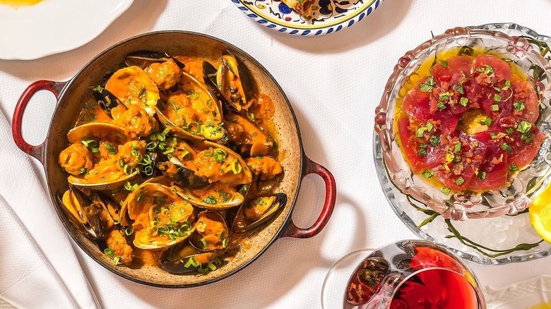 plated clams, mussels, and crudo on the table at Carbone Miami